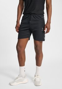 Schwarze Sportshorts aus feuchtigkeitsableitendem Material, mit elastischem Bund, Kordelzug und Logodetail am linken Bein.