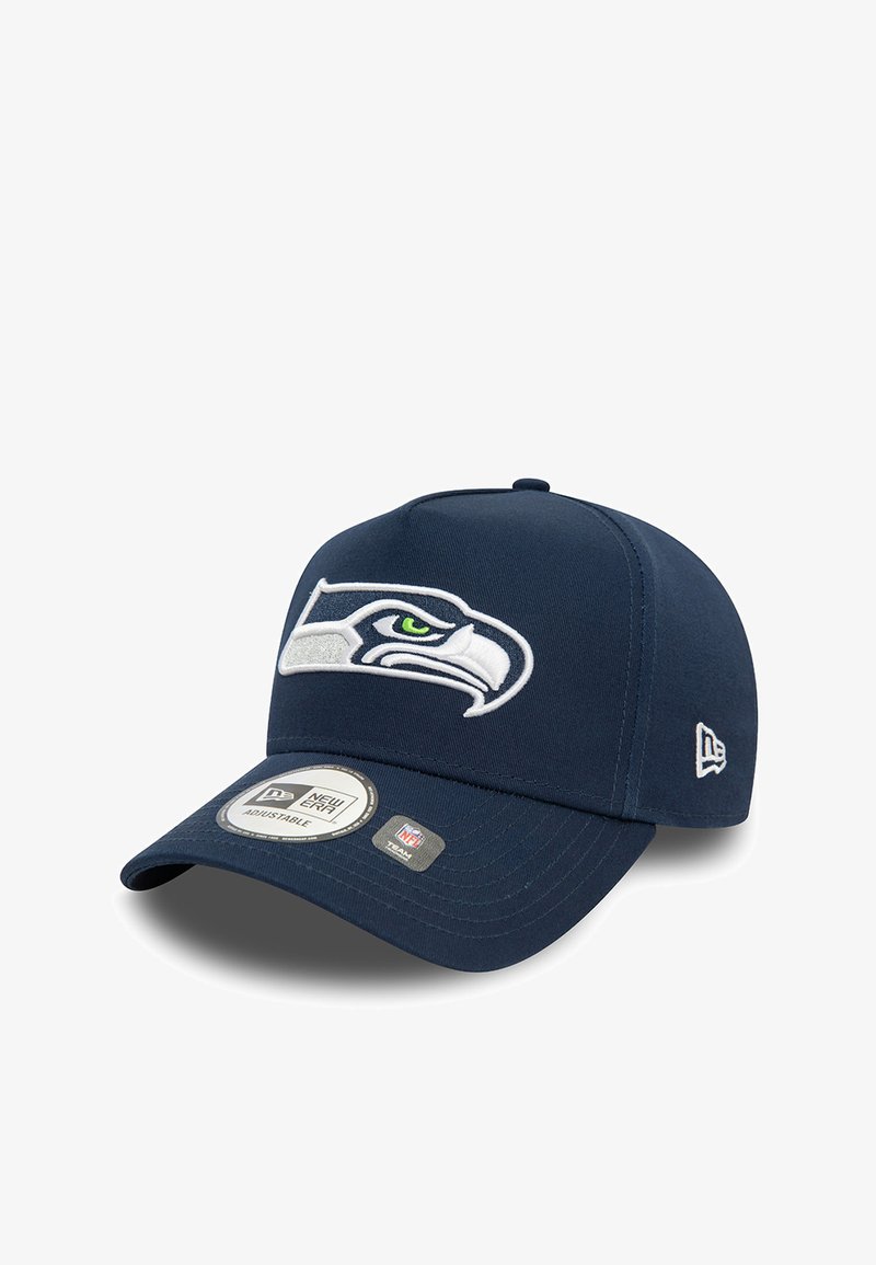Navy blue baseball cap made of fabric with an adjustable strap. Features embroidered Seahawks logo and textured brim with brand labels.