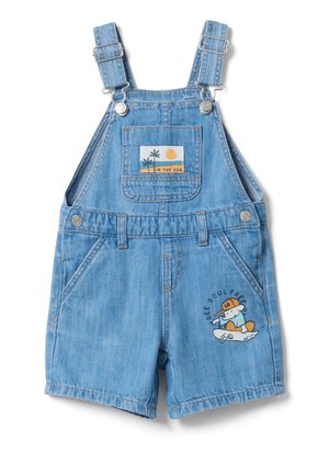 Salopette en denim bleu clair pour tout-petit avec bretelles ajustables, poche avant ornée d'un écusson représentant des palmiers et un soleil, ainsi qu'un dessin animé de skateur avec le texte "Free Soul Free".