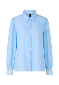 Light blue blouse with white polka dots, button-down front, collar, and long sleeves. Cuffs feature detailed white lace accents.