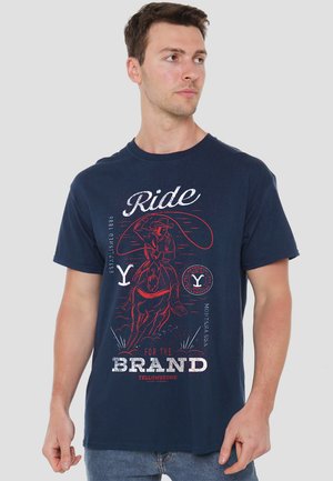 Navy blue short-sleeve T-shirt made of cotton with a graphic print featuring a cowboy on a horse, accented with white and red text.