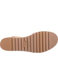 Lightweight, rubber outsole with a wave pattern and brand logo. The surface is textured with ridges for enhanced grip.