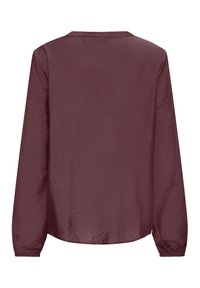 Blouse à manches longues de couleur mauve foncé avec un col rond et des poignets élastiques, présentée de dos sur fond blanc.