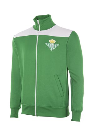 Groene sportjas met rits, wit bovenpaneel op de borst en Real Betis clublogo op de linkerborst, met zijzakken en geribbelde manchetten.