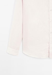 Light pink linen shirt with long sleeves, buttoned cuffs, and a straight hemline, featuring a front button closure and subtle texture.