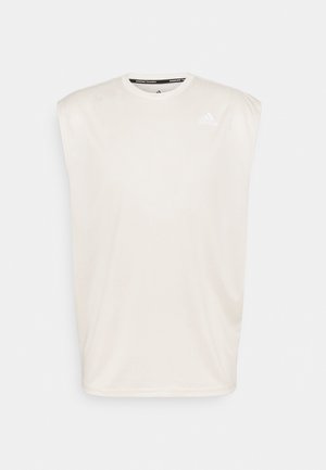 Jasno beżowy bezrękawnik sportowy wykonany z gładkiego materiału. Posiada okrągły dekolt oraz małe białe logo na górnej lewej części klatki piersiowej.