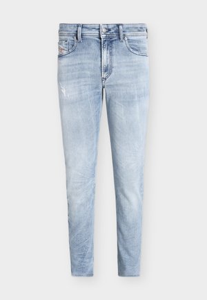 Lys blå slim-fit jeans med lett slitasje på venstre lår, fem-lommer design, knapp og glidelås.