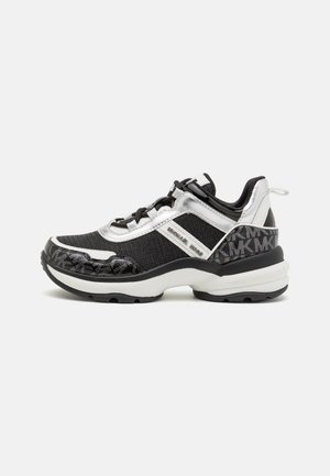 Baskets basses noires et argentées avec semelle blanche épaisse, laçage à l'avant, logo Michael Kors sur le côté et partie talon à motif.