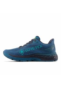 Blauer Laufschuh mit GORE-TEX-Branding. Verfügt über ein strukturiertes Mesh-Obermaterial, eine kontrastierende dunkle Sohle und reflektierende Akzente an den Schnürsenkeln.