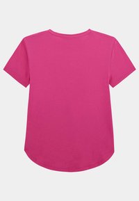 T-shirt rose à manches courtes avec un col rond, une coupe décontractée et un ourlet courbé en bas. Tissu en coton lisse sans motifs.