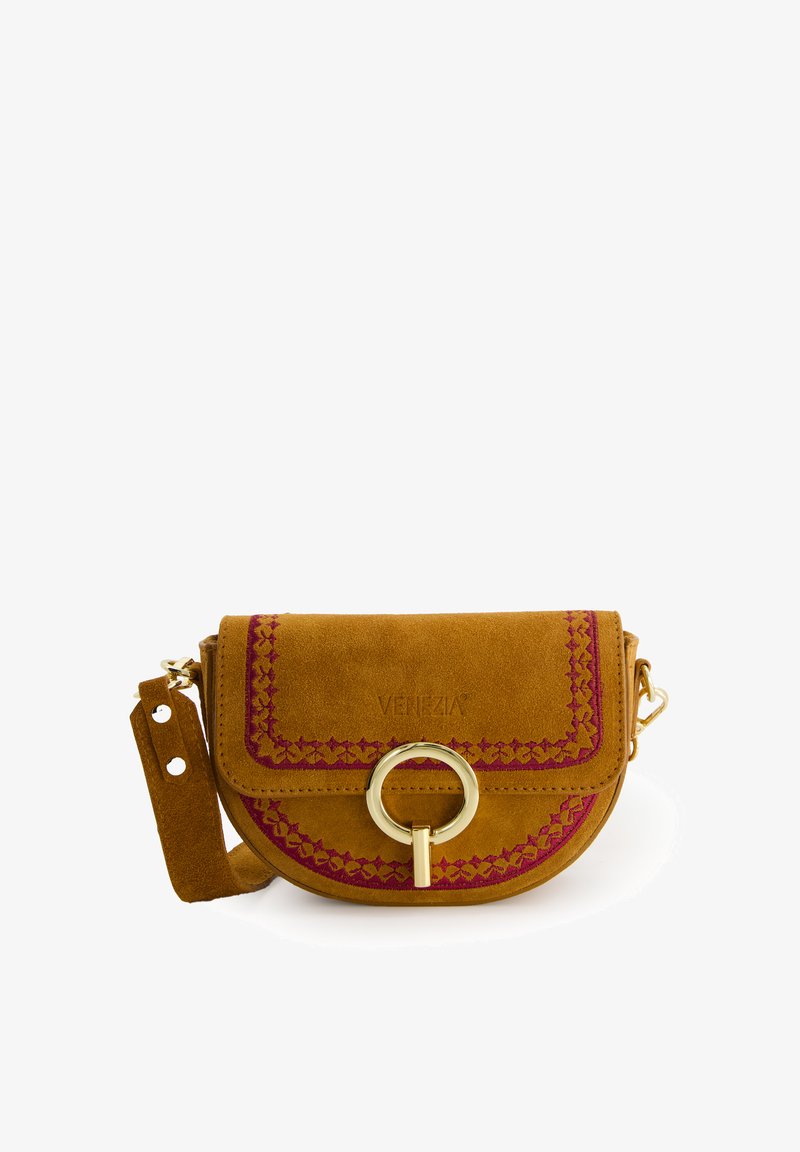 Suede crossbody bag in mustard with pink embroidery. Rounded shape, gold hardware accent, adjustable strap, and flap closure.