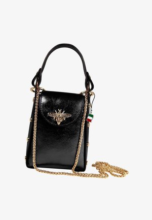 Black leather handbag with top handle, gold chain strap, and gold bee embellishment on front flap, featuring a small Italian flag charm.