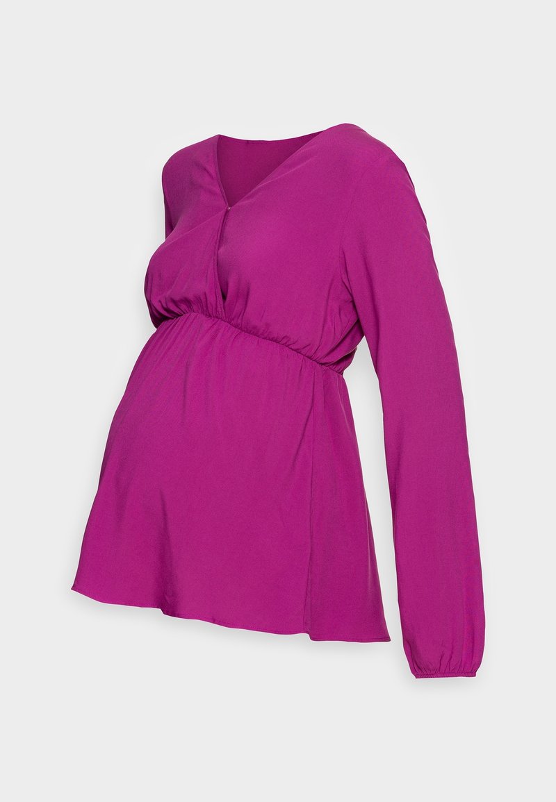 Haut de maternité violet à manches longues, encolure en V et taille froncée. Tissu doux avec un design fluide, idéal pour accueillir un ventre en pleine croissance.