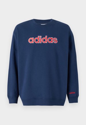 Sweat-shirt bleu marine à col rond avec manches longues et logo "adidas" en grosses lettres rouges et blanches sur la poitrine.