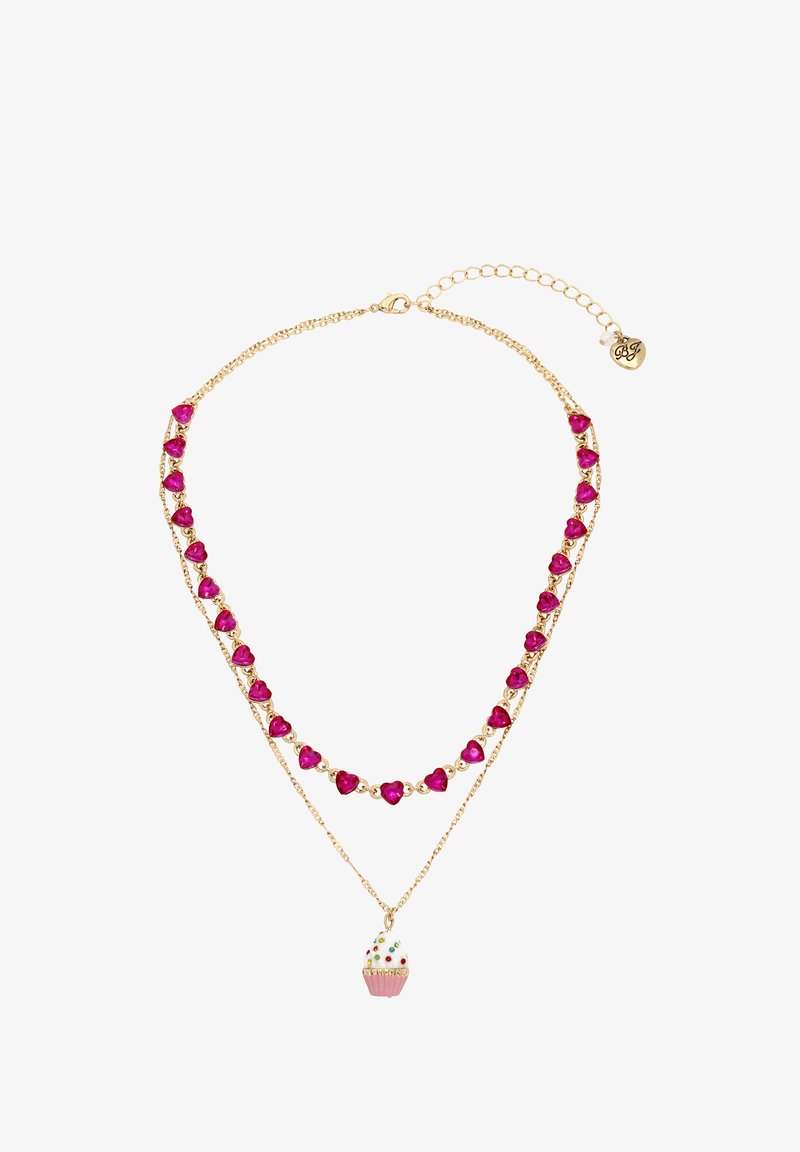 Gold necklace featuring two strands. One strand has pink heart-shaped stones, the other a cupcake charm with colorful sprinkles.