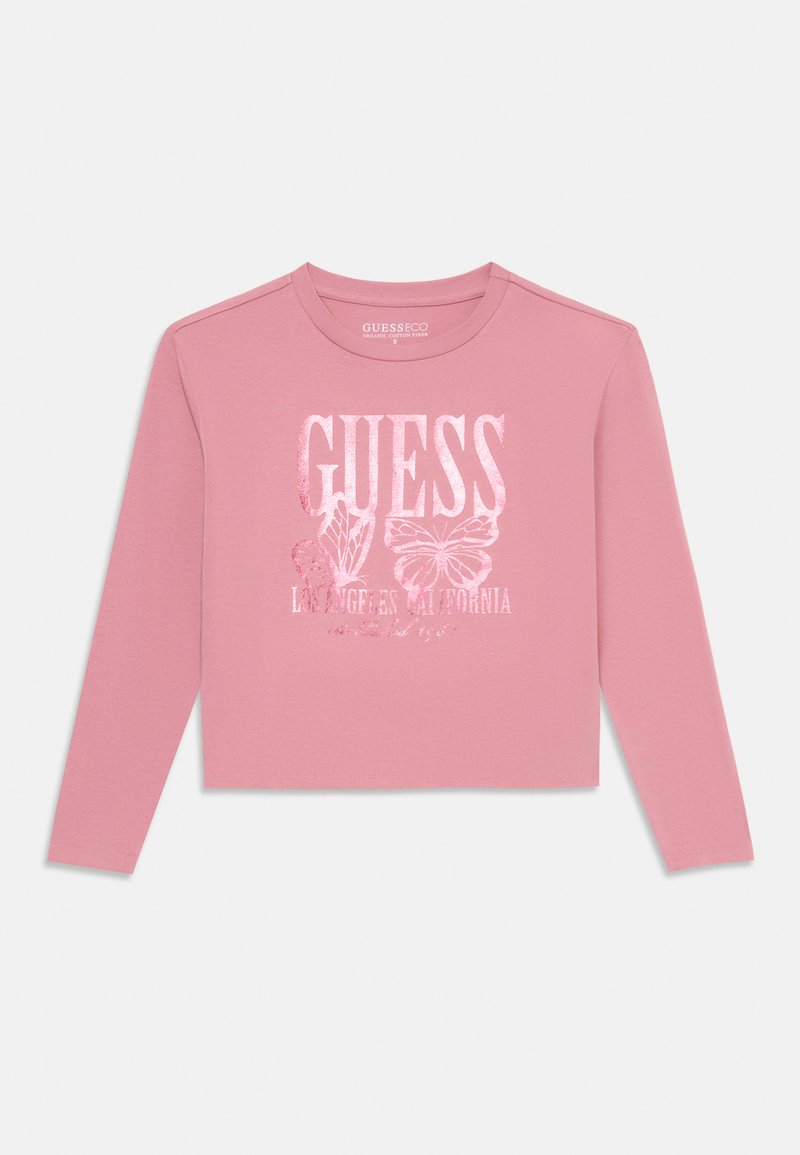 Šviesiai rožinė ilgomis rankovėmis trumpa palaidinė, pagaminta iš ekologiško medvilnės, su "GUESS" logotipu, drugelio grafika ir "Los Angeles California" tekstu.