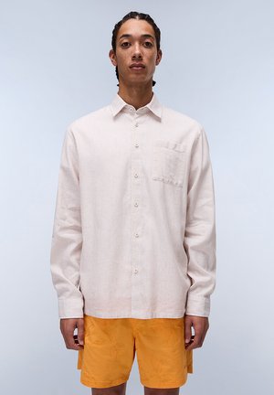 Lightly striped, long-sleeve button-up shirt in soft fabric, featuring a chest pocket and white buttons, paired with textured orange shorts.
