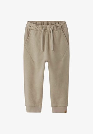 Beżowe spodnie dresowe dla malucha z elastycznym pasem, regulowanym ściągaczem, przednimi kieszeniami i ściągaczami przy kostkach.