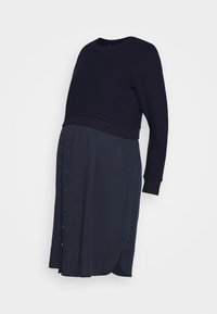 Mørkeblå kjole med en tekstureret langærmet top med rund halsudskæring og en glat, knap-front nederdel med sideslids.