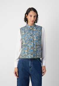 Λουλουδάτο γιλέκο σε μπλε, κρέμα και καφέ με κλείσιμο από κουμπί και δύο μπροστινές τσέπες. Διαθέτει ψηλό γιακά και αντίθετο φινίρισμα.