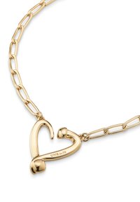 Collar de cadena chapada en oro con un colgante en forma de corazón, de textura suave y extremos redondeados, que muestra detalles de marca grabados.