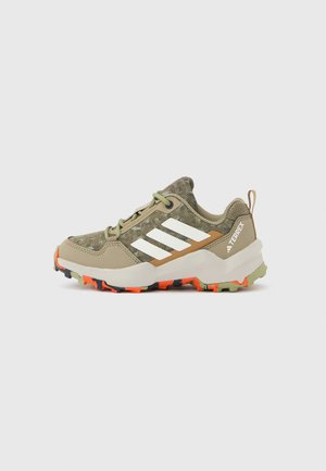 Lightweight hiking shoes in olive green and beige with three white stripes, textured upper, and rugged orange and black outsole.