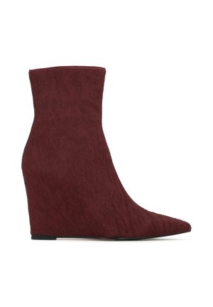 Burgundy wedge ankle boots with a pointed toe, made of a textured material resembling fur, featuring a sleek silhouette and flat sole.