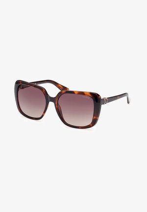 Schildpattfarbene quadratische Sonnenbrille mit verlaufenden Gläsern. Verfügt über ein metallicfarbenes Markenakzent am Scharnier. Glatter Kunststoffrahmen mit dicken Bügeln.