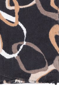 Tessuto stampato caratterizzato da anelli sinuosi in beige, marrone e bianco su uno sfondo scuro; i bordi presentano una finitura grezza.