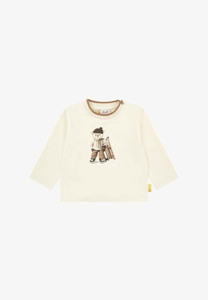 Langärmliges cremefarbenes Shirt mit einem Bärenmotiv in Braun, Schnee und einem Schlitten, runder brauner Kragen und Knopfdetail an der Seite.