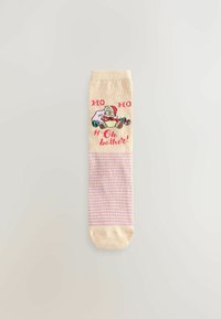 Knee-high socks in beige with pink stripes. Features graphic of a character in a Santa hat, text "HO HO H Oh bother!" in red. Soft cotton blend.