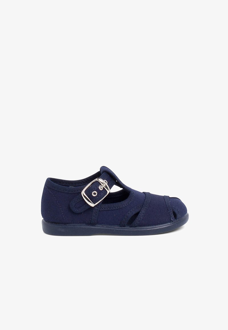 Navy blue canvas shoe with cutouts and a side buckle closure. Features a flexible rubber sole and reinforced stitching for durability.