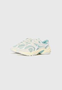Sneakers in light gray with mint green accents. Mesh and suede material, rounded design, padded collar, and textured rubber outsole.