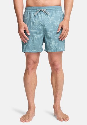 Pantaloncini da bagno turchesi con motivo a palme, cintura elastica con coulisse e vestibilità comoda, realizzati in tessuto leggero.
