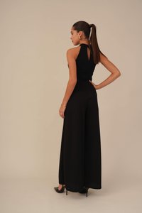 Black jumpsuit with a fitted bodice and wide-leg design. Features a keyhole back detail and smooth, textured fabric.
