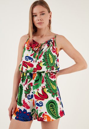 Combinaison colorée à motifs présentant une base blanche avec des motifs paisley en rouge, vert, bleu et orange. Liens au niveau du col et taille élastique.
