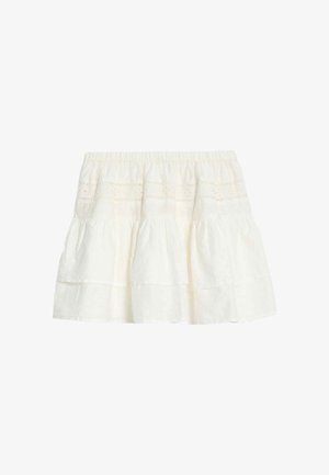 Jupe mini blanche à volants avec taille élastique et délicate broderie œillets sur tissu léger.