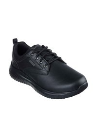 Sneaker nera con tomaia sintetica liscia, punta rotonda, design con lacci e suola imbottita, caratterizzata da un piccolo logo sul lato.
