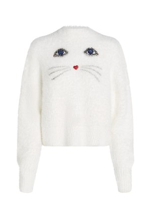 Pull court en peluche blanc avec un motif de visage de chat. Yeux en gemmes bleues scintillantes, cœur rouge et moustaches argentées en embellissements.