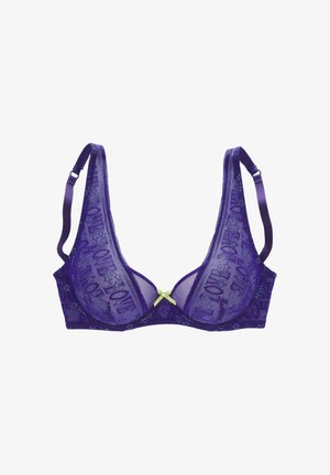 Purple lace bra with adjustable straps and a small green bow in the center, featuring floral and text patterns on the fabric.