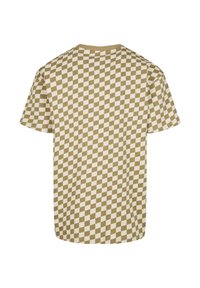 T-shirt à manches courtes avec un motif de damier géométrique en beige et crème. Fabriqué en tissu doux avec une coupe décontractée.
