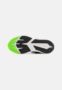 Nike schoen zool met een zwarte rubberen basis, gestructureerde groeven en een felgroene accent op de hak voor verbeterde grip.