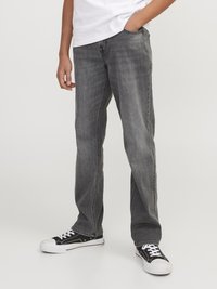 Gray denim jeans with a straight-leg design, five pockets, and belt loops. Worn with black sneakers featuring white soles and laces.