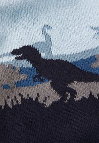 Megzta megma, kuriame pavaizduota mėlyna ir smėlio spalvos dinozaurų sistema. Dizainą sudaro dinozauro siluetas ant tekstūruoto fono.
