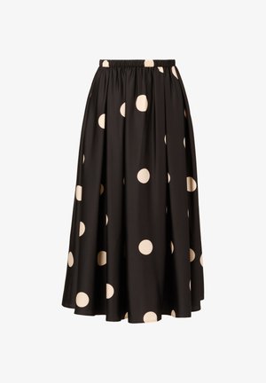 Black knee-length skirt with a gathered elastic waistband, featuring large cream polka dots on a smooth fabric. No additional accents visible.
