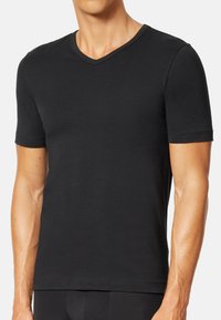 Black short-sleeve V-neck t-shirt made of smooth fabric, featuring a fitted design and a subtle texture with a clean, modern silhouette.