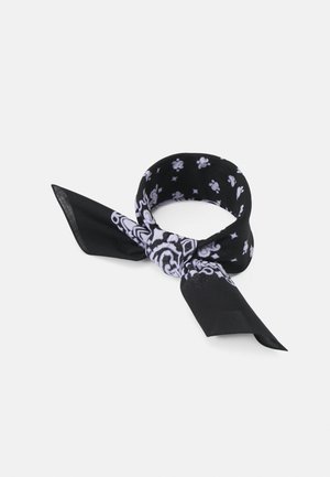 Black bandana with white paisley and floral patterns, folded and tied in a loose knot against a plain light background.
