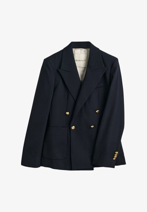 Blazer croisé bleu marine en laine, avec de grands boutons dorés et un col cranté. Comprend deux poches frontales.