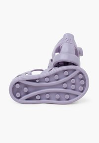 Purple plastic sandal with a textured sole and adjustable strap; the style features a molded design and the number "21" embossed on the back.
