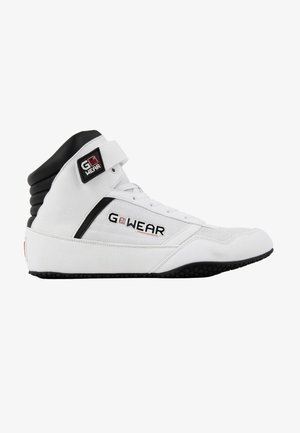 Hoge sport schoen in witte stof met zwarte accenten, voorzien van een rubberen zool, versterkte neus en verstelbare klittenbandsluiting.